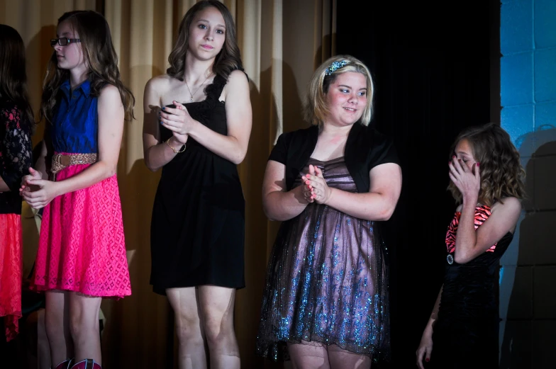 a group of beautiful young women standing next to each other