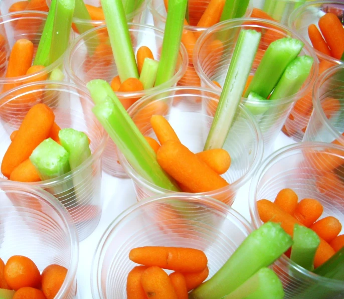 there are many cups that have carrots in them