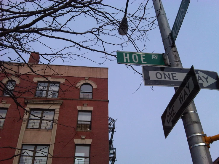 one way sign, two street names and one is on the corner