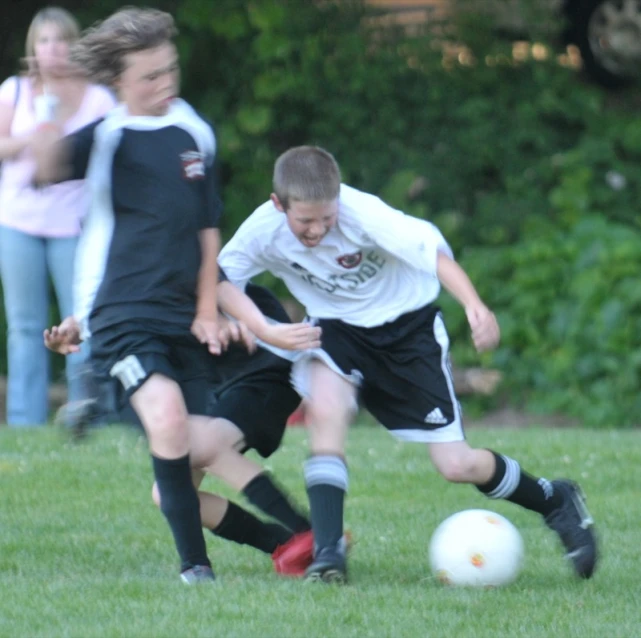 a couple of boys are on a soccer field