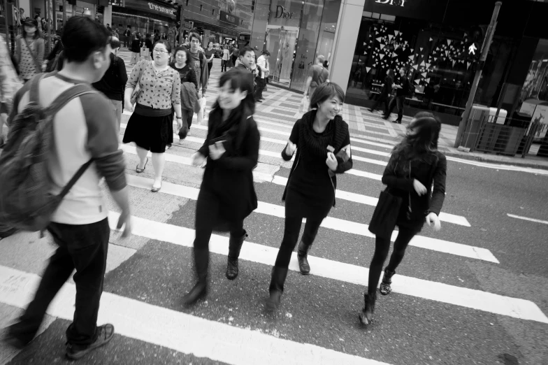 a black and white po of people crossing the street