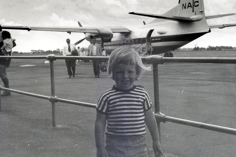 a small child standing in front of an airplane