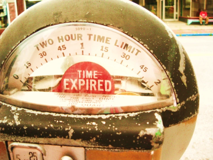 an expired parking meter is seen with graffiti