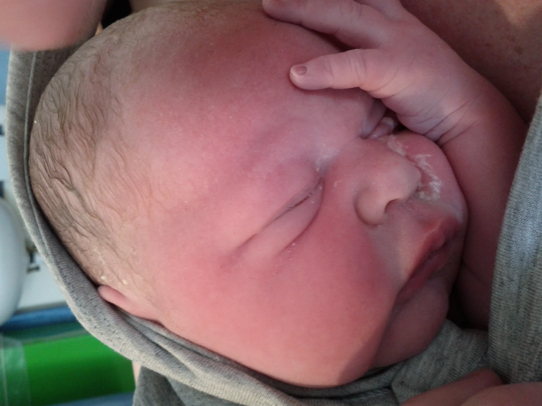 a close up of a baby with a covering over his head