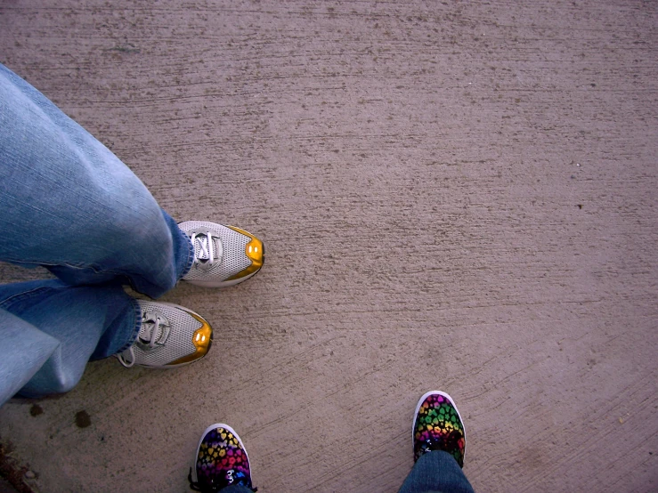 four people with their shoes on standing in the street