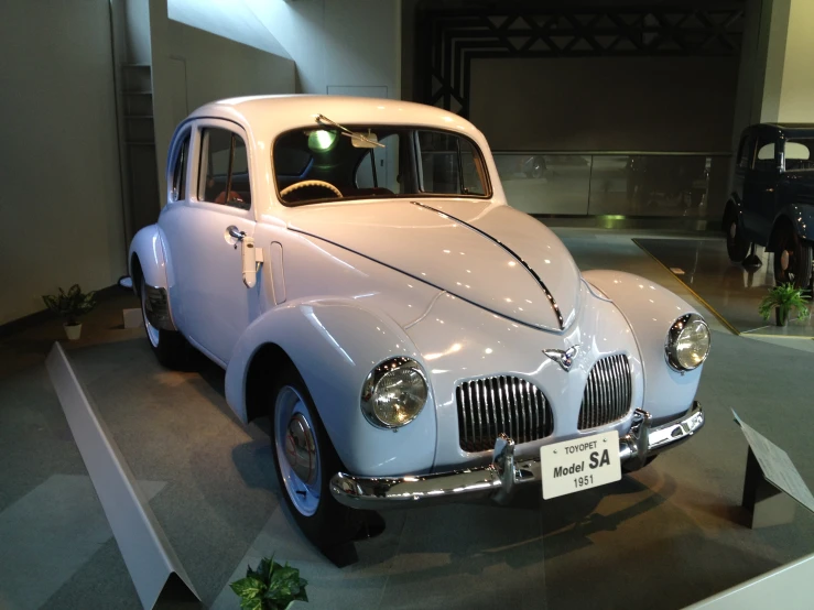 there is a vintage white car on display at the show