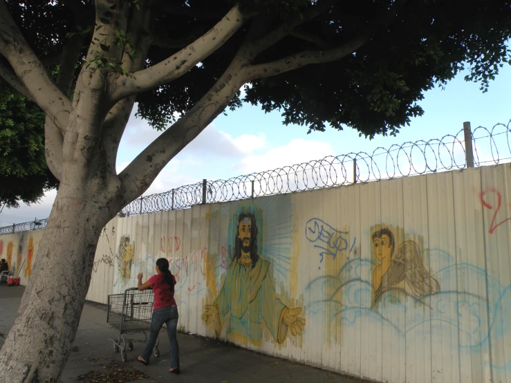 a person that is standing next to a fence