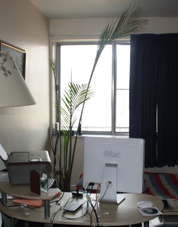 an office with desk with several computers and other personal devices on it