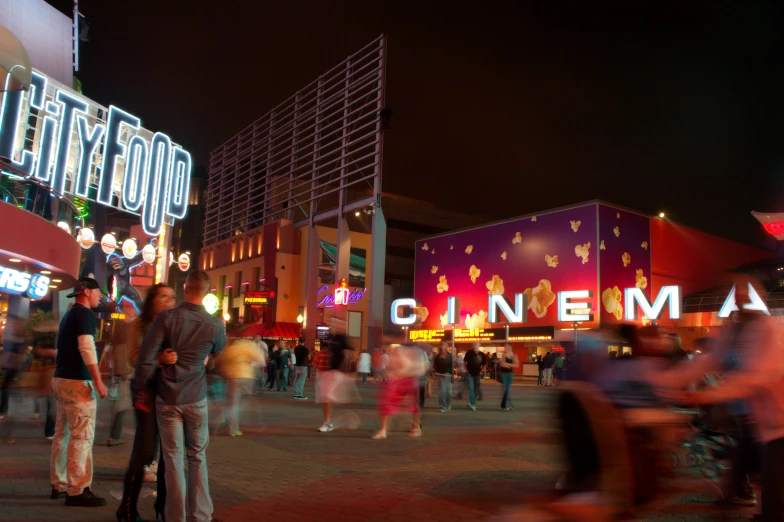 people are gathered outside a theatre in a city