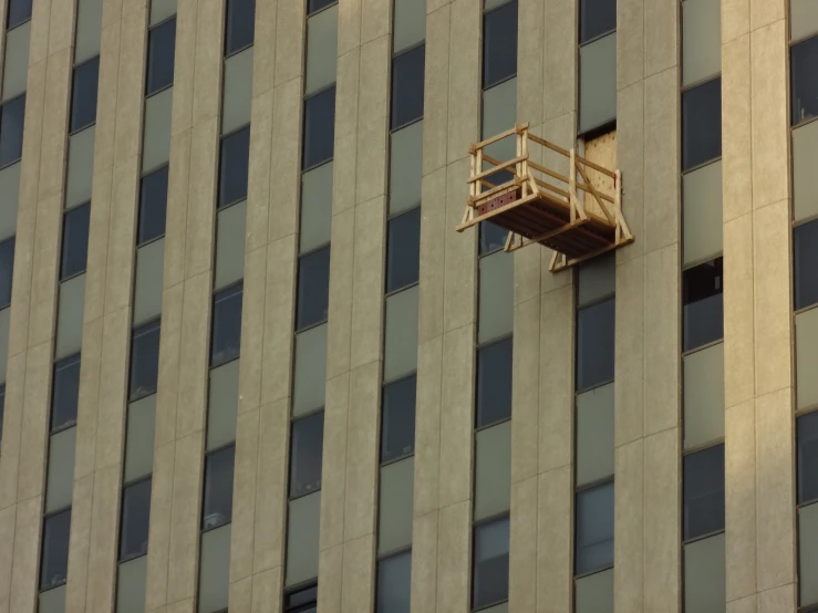 a building with some windows and a ladder on the side