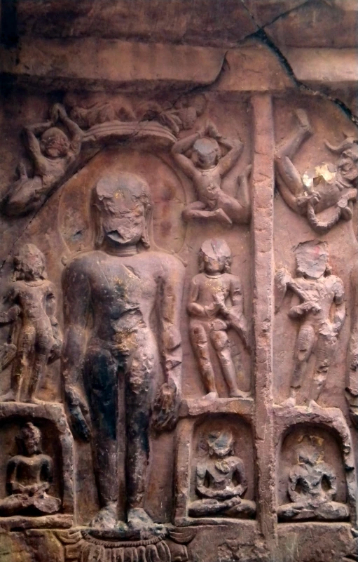 an ornate carved wall, with various figures