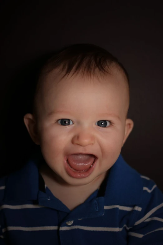 baby making a funny face with his mouth open