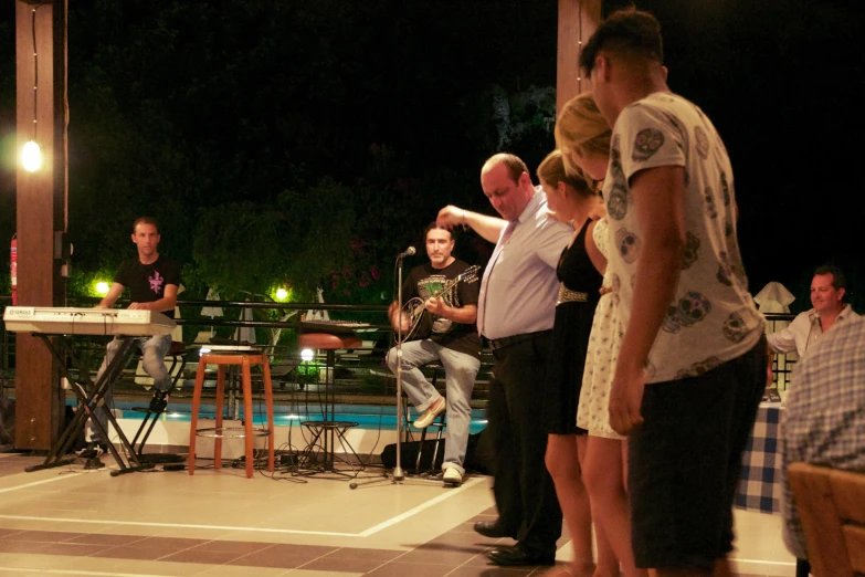 a group of people standing on top of a tiled floor