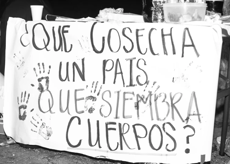 a banner is on the sidewalk for a protest against police