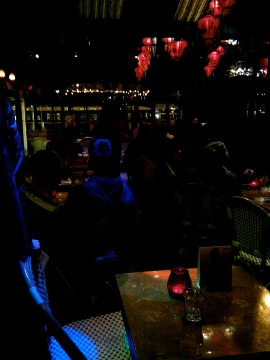 tables and chairs are covered in lights that also serve as the main light for the bar