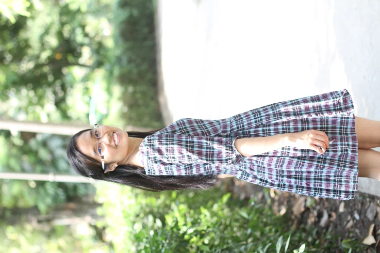 a woman smiles and poses for the camera