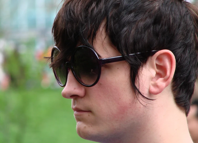 a close up of a man in sunglasses with short hair