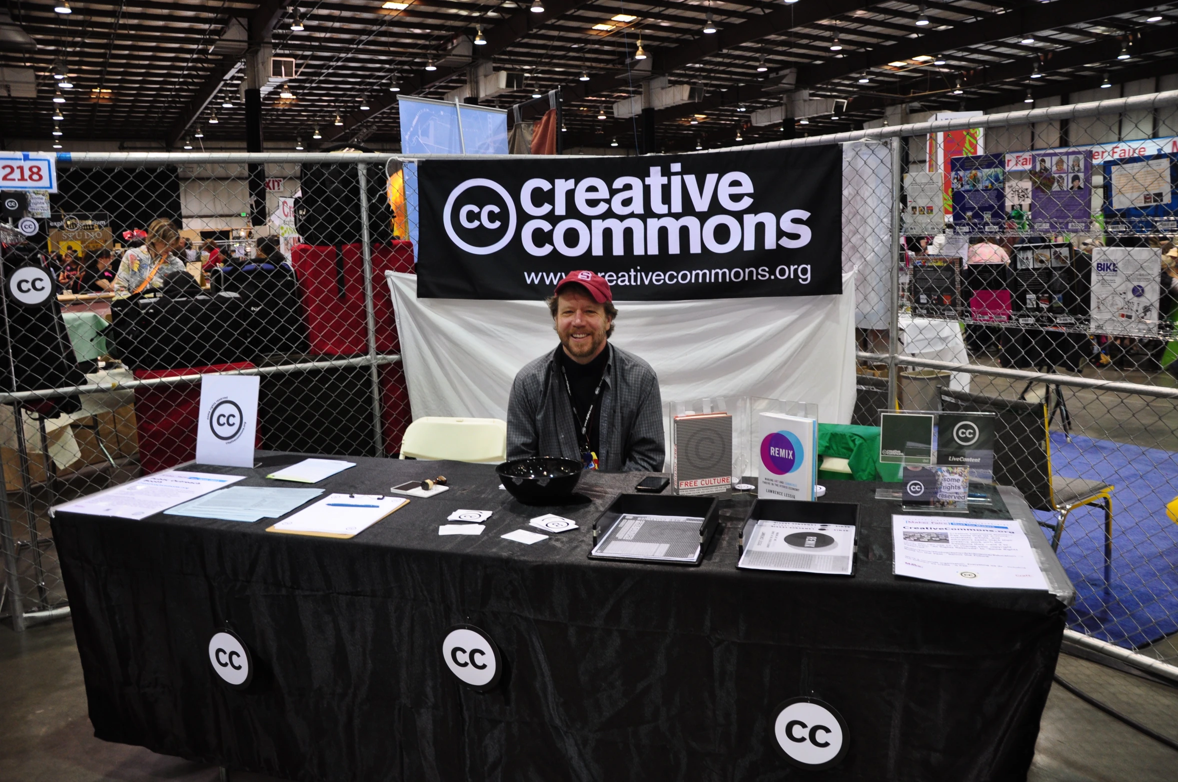 a table with a man standing behind it