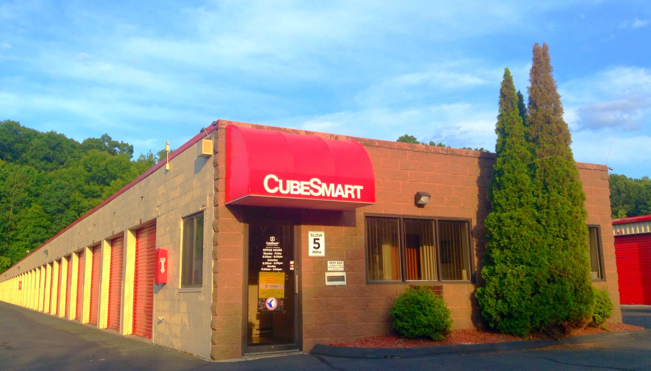 a small business with red awnings and doors