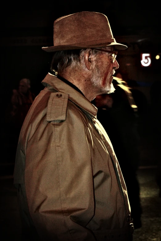 a man wearing a hat and jacket with a long beard