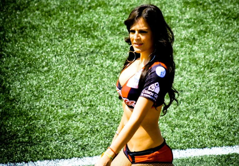 a woman in bikinis stands on the field