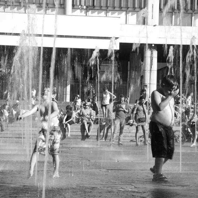 black and white image of s playing in the fountains