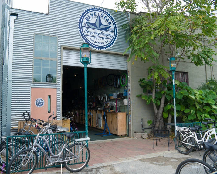 several bikes are parked outside of the shop