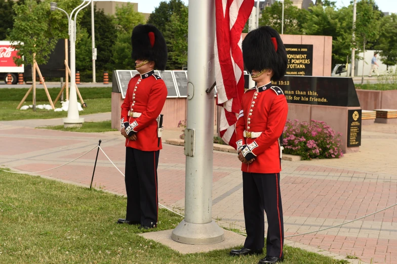 two guard officers stand on their duty outside a monument