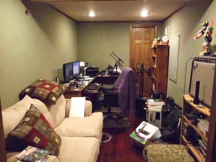 view of a room that includes a computer, laptop and desk