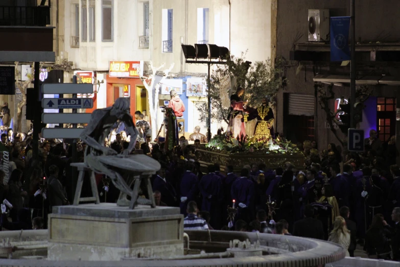 a crowd of people gathered around and walking around a building with many doors