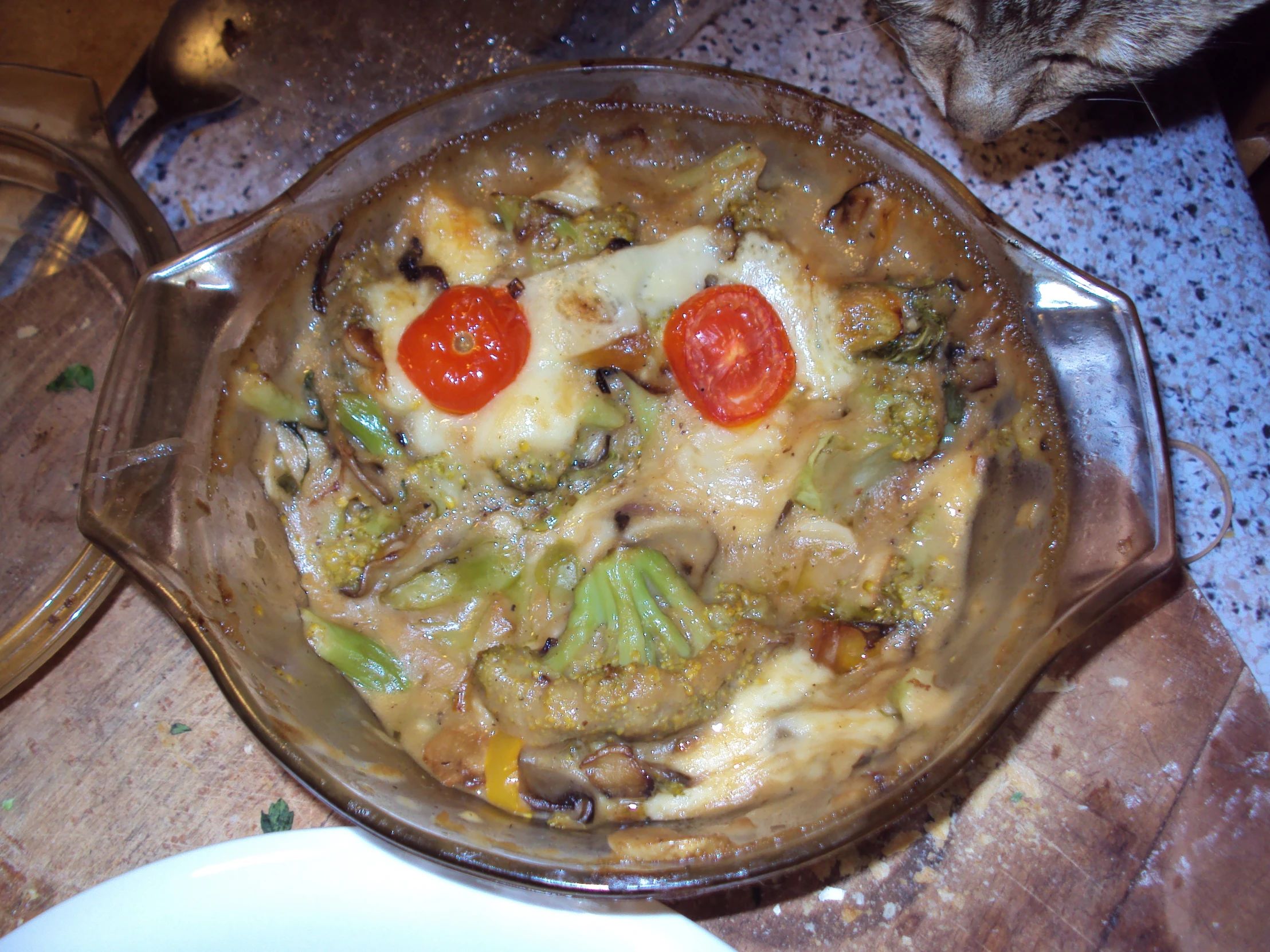 a casserole in glass dish with a red pepper