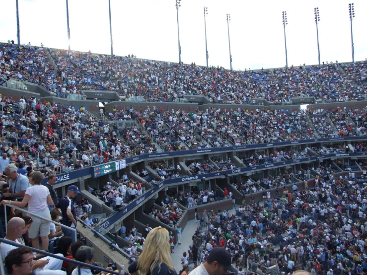 a stadium full of people who are standing for a picture