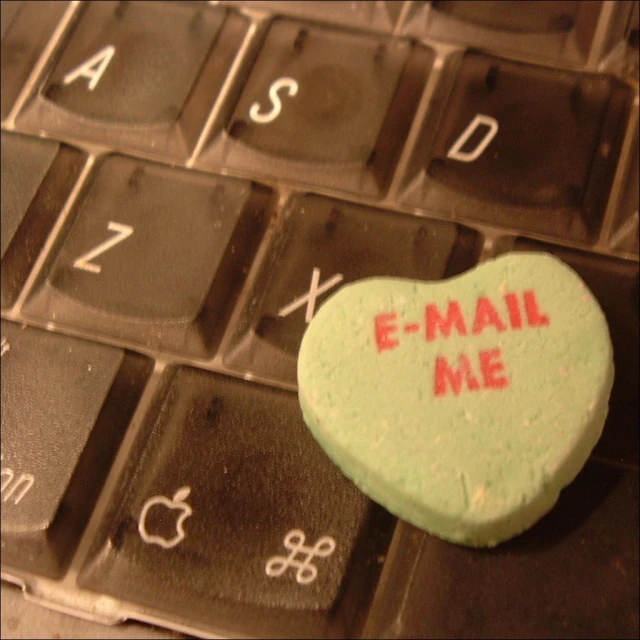 a computer keyboard with an heart on top of it