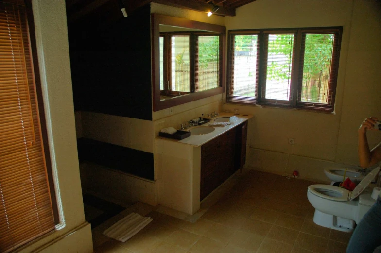 the bathroom with a lot of storage space has three sinks