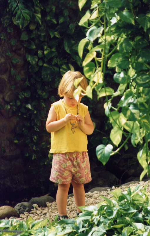 little girl standing alone with hands holding soing