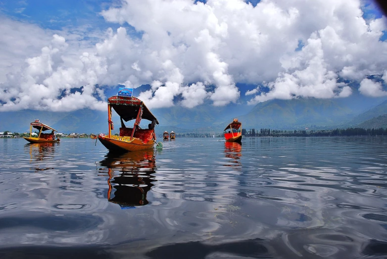 some boats are sailing in some clear water