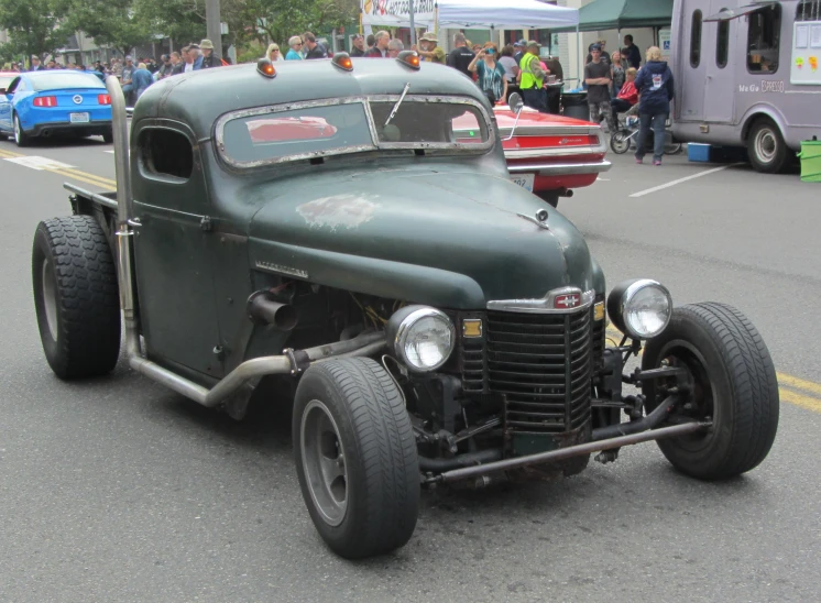 an antique car driving down the street