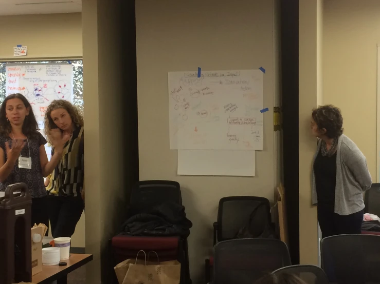 people in a conference room with a white board