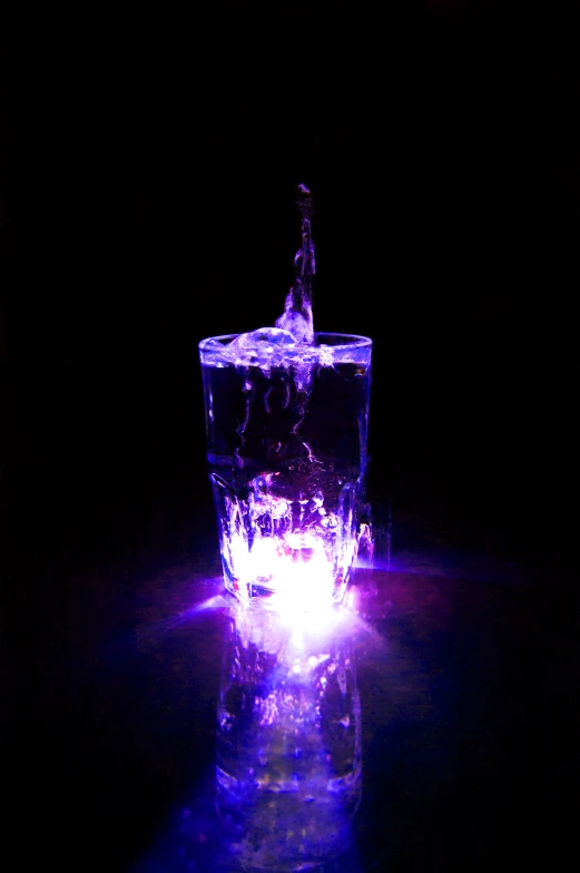 a bottle of liquor being filled into a glass on the table