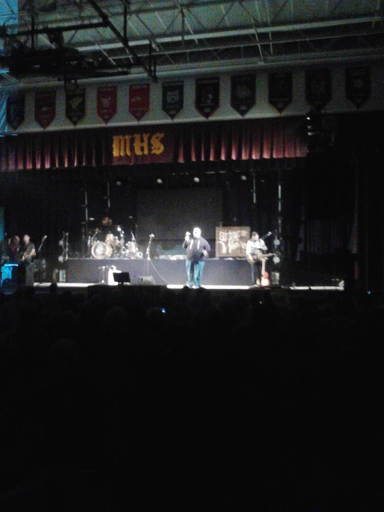 people playing on stage in an empty theater