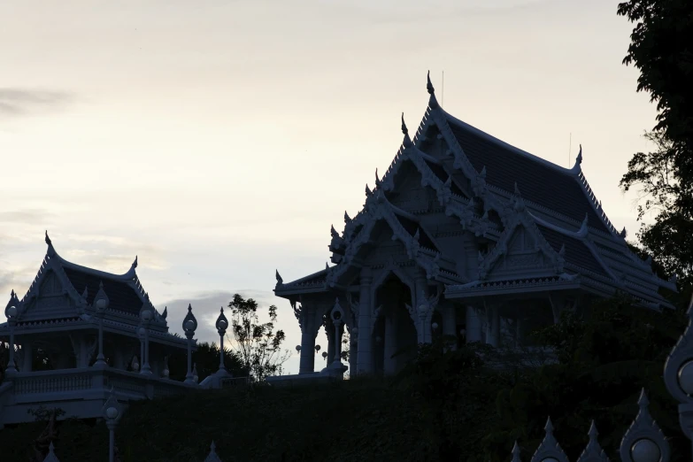a couple of ornate architecture is shown at dusk