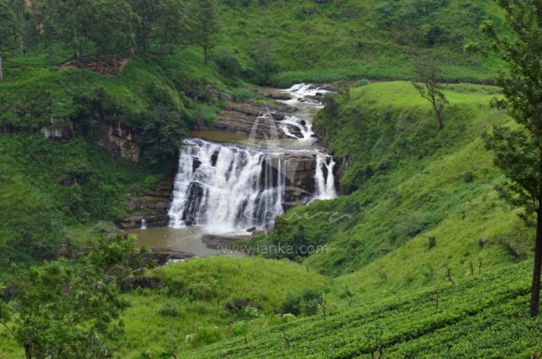 a view of some very pretty waterfalls in a jungle