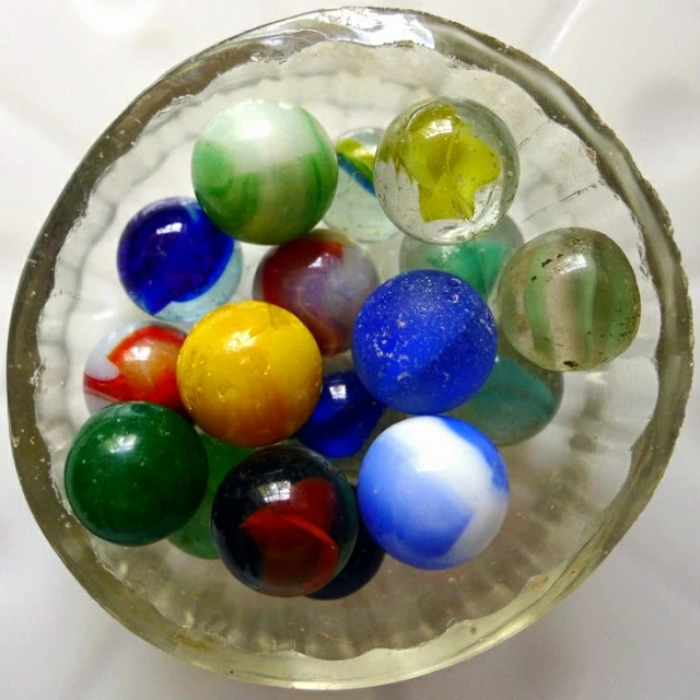 there are eight different colored marbles in a bowl