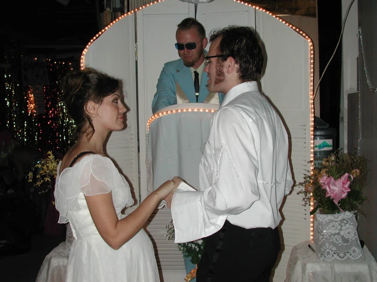 a man standing next to a woman in a dress