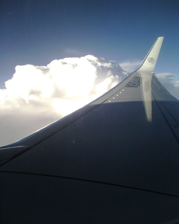 a view from the inside of a plane flying through a cloud filled sky