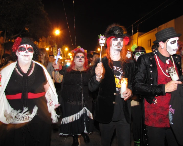 people in costume standing with their faces painted