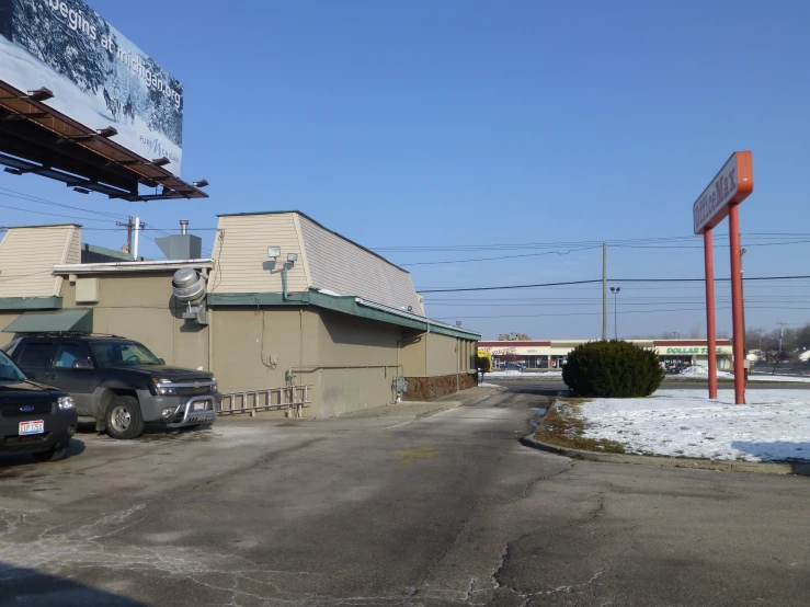 the car is parked in front of the building