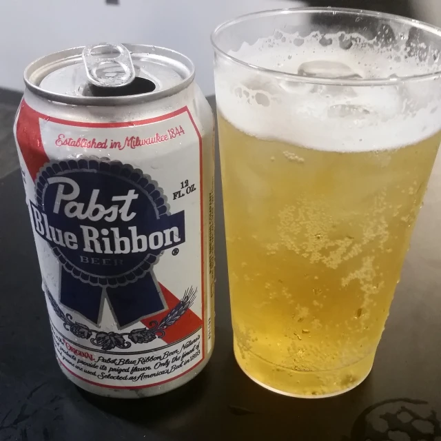 a can of blue ribbon beer next to a drink