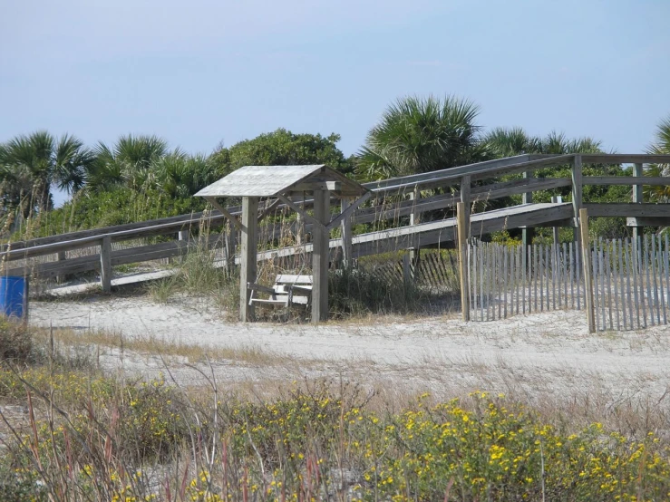 wooden bench along the boardwalk and boardwalk side by side