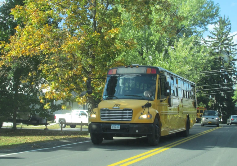 an eighteen wheeler bus driving on a suburban street